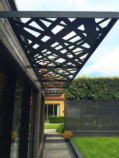 an outdoor area with grass and plants on the side