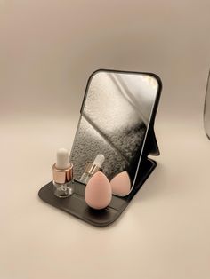 an image of a mirror and cosmetics on a table