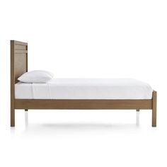 a bed with white sheets and wooden headboard on top of it, against a white background