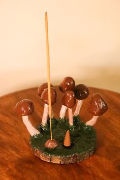 a group of mushrooms sitting on top of a wooden table next to a toothpick