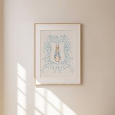 a white wall with a blue frame hanging on it