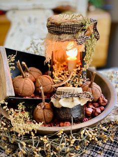 a bowl filled with pumpkins and other decorations