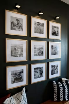 black and white photographs are hung on the wall above a bench in a living room