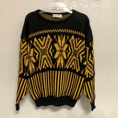 Black and yellow, black and yellow!  You know what it is!  An awesome sweater (awesome sweater). Details: 100% Acrylic Made in 1970s (70s) Made in USA Size: Women's Medium (M) Brand: Glamour-Knit Condition: Very good  Machine or hand wash warm Main colors: Black, yellow Measurements: Chest 44.5 in Length  23.5 in Shoulder 25 in Disclaimer:  It is the buyer's responsibility to wash the article of clothing before wearing it.  Any mishaps that may occur due to wearing the clothing before washing it are the responsibility of the buyer and not TheGreatAdvintage.  (The shirts have been washed and cleaned beforehand, but still wash it before you wear it!) My collection consists of pieces that are of vintage condition, which means that all my items are second-hand and used. Customers are not purch Vintage Black Sweater For Fall, Vintage Black Tops For Winter, Yellow Crew Neck Sweater For Winter, Yellow Vintage Tops For Winter, 90s Style Black Sweater For Fall, Retro Yellow Sweater For Fall, Vintage Black Winter Top, 90s Black Sweater For Fall, 90s Style Black Winter Sweater