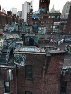 black and white photograph of an urban area with graffiti on the walls, stairs and buildings