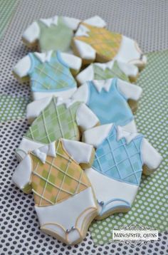 baby ones decorated cookies on a green and white checkered tablecloth