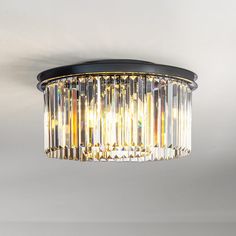 This odeon round crystal flush mount is a elegant light fixture with a contemporary look that will add mid-century modern decor style to your home. Its two tiers and nine lights create plenty of warm, welcoming light. The sleek black finish frame is strong and durable. The clear crystal hangs around the frame that forms a round shade, each crystal comes with a thick, triangular profile that delivers maximum refraction and reflection, enhancing its visual profoundness and artistry even further. A Black Flush Mount Light, Wagon Wheel Chandelier, Light Fixtures Flush Mount, Mid Century Modern Decor, Modern Round, Pendant Chandelier, Flush Mount Lighting, Everly Quinn, Flush Mount Ceiling