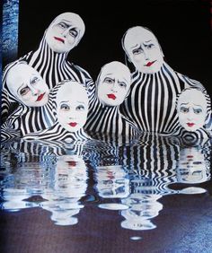 an image of some people in striped outfits with their faces painted like clowns on them