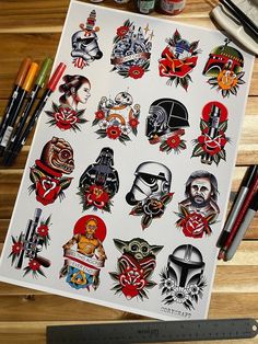 a variety of tattoos on a piece of paper next to some markers and pencils