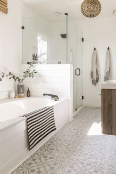 a white bathroom with black and white decor