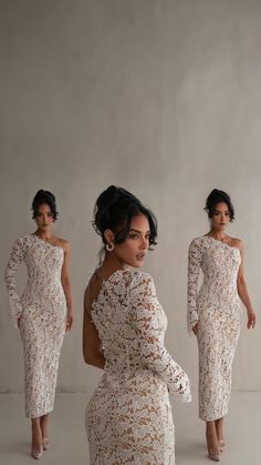 three women in white dresses standing next to each other with one woman's back facing the camera