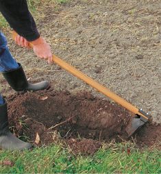 a person digging in the ground with a shovel