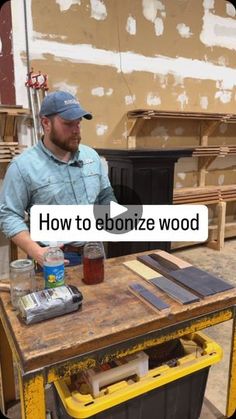 a man is sitting at a table with some wood on it and the words how to ebonize wood above him