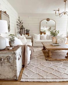 a living room filled with furniture and a large mirror on the wall above it's coffee table