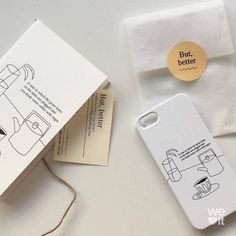 an iphone case sitting on top of a white table next to a paper bag and tag