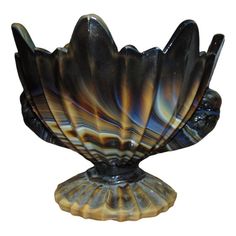 an art glass bowl sitting on top of a stand