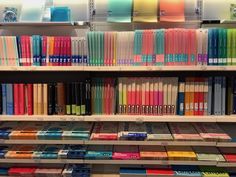 rows of books on shelves in a store with many different colors and sizes to choose from