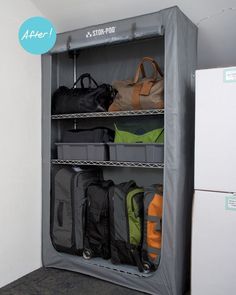 an open closet filled with lots of bags and suitcases next to a wall mounted refrigerator