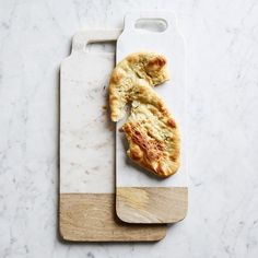 a piece of food on a cutting board next to a knife with it's end cut off