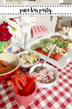 a table topped with plates of food and bowls of salads on top of it