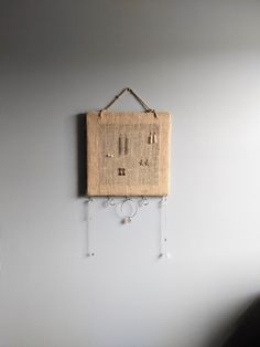 a wall hanging on the side of a white wall