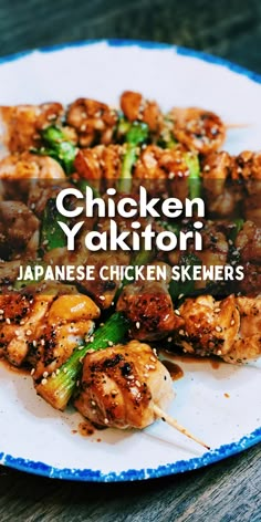 a plate with chicken skewers on top of it