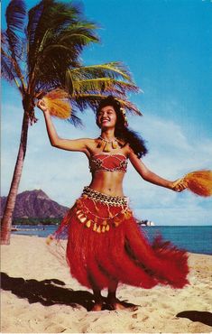 a woman in a red hula dancing on the beach with palm trees behind her