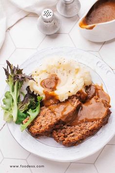 meatloaf, mashed potatoes and gravy on a plate with broccoli