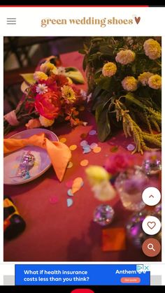 a table with flowers and confetti on it