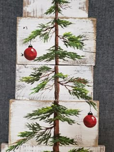 a christmas tree made out of wood with ornaments hanging from it's branches and pine cones