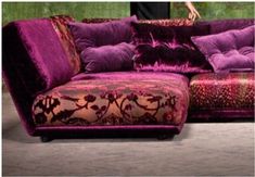 a large purple couch sitting on top of a floor