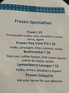 a menu for frozen beverages is shown on a plate with utensils in it