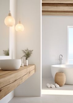 a bathroom with a large white bathtub next to a sink and window in it