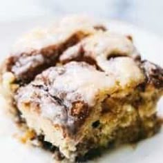 a close up of a piece of cake on a plate with icing and chocolate