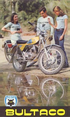 two women and a man standing next to a motorcycle