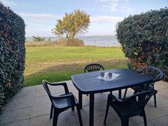 an outdoor table and chairs on a patio