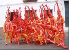 a group of people dressed in orange and yellow