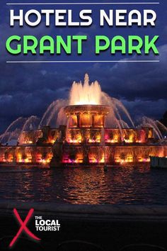 the hotel near grant park is lit up with colorful lights and fountains in front of it