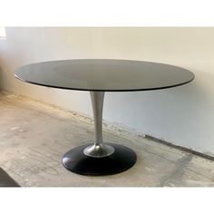 an oval glass table with metal base