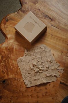 a piece of wood that is sitting on top of a table with a box next to it