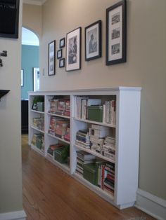 the bookshelves are full of books and pictures on the wall in this room