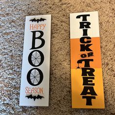 two halloween bookmarks on the floor with happy trick or treat written in black and orange