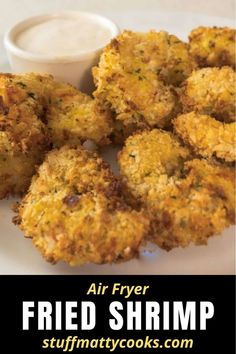 fried shrimp patties on a plate with ranch dressing and dipping sauce in the background