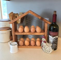 there is a chicken and some eggs on the counter next to a bottle of wine