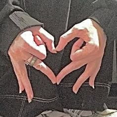 two hands making a heart shape with their fingers