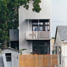 a person standing on the balcony of a house