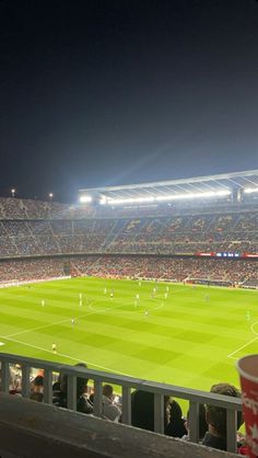 an empty soccer stadium at night with fans