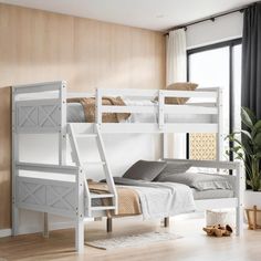 a white bunk bed sitting next to a window