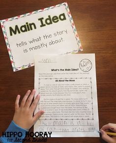 a person is holding their hand over a piece of paper with the words main idea on it