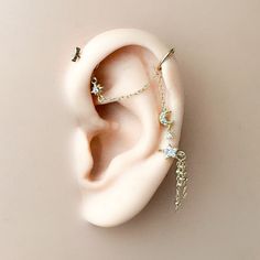 a pair of ear piercings on top of a white object